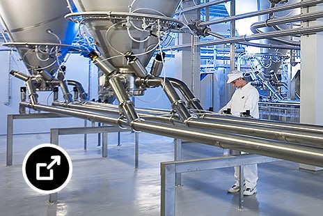 Large industrial food processing equipment on a factory floor 