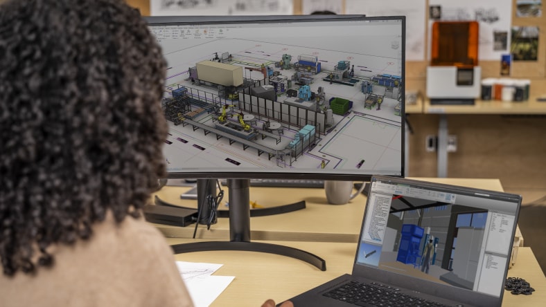 a woman views a 3d model on two screens