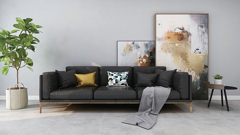 Living room with plant, couch, a side table, and modern art